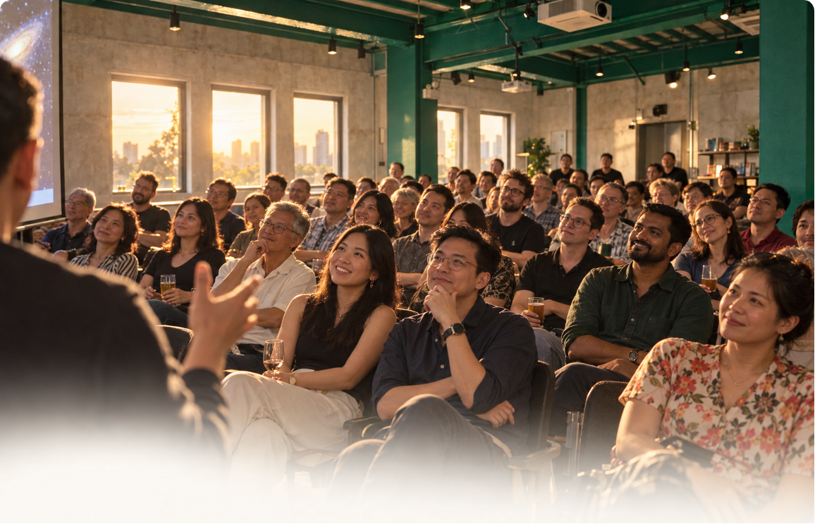 A seated audience listening to a speaker